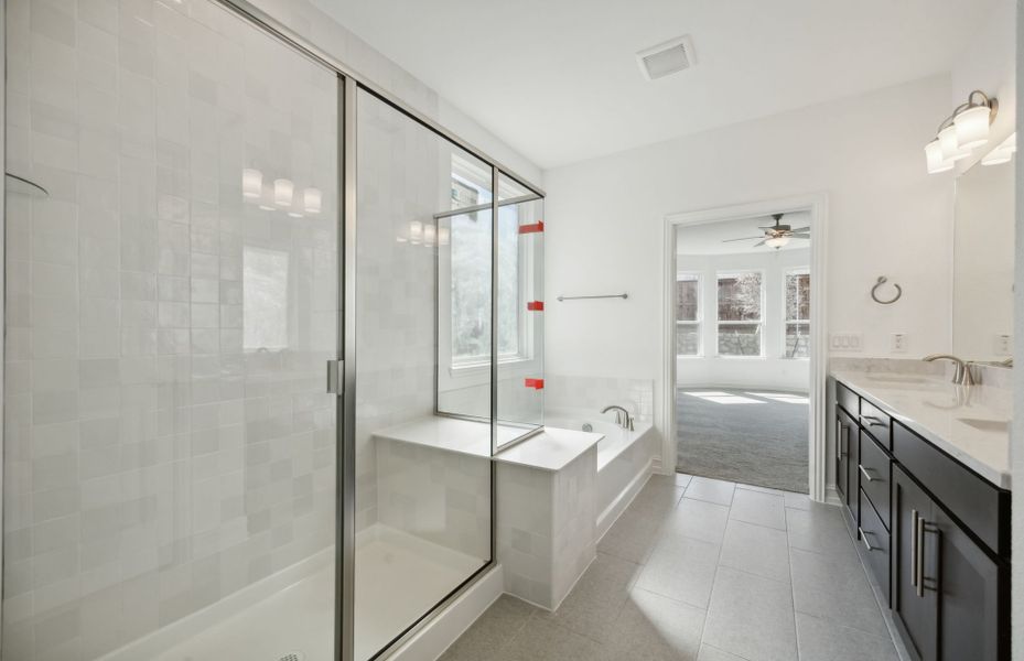 Elegant owner's bathroom with oversized shower*real home pictured