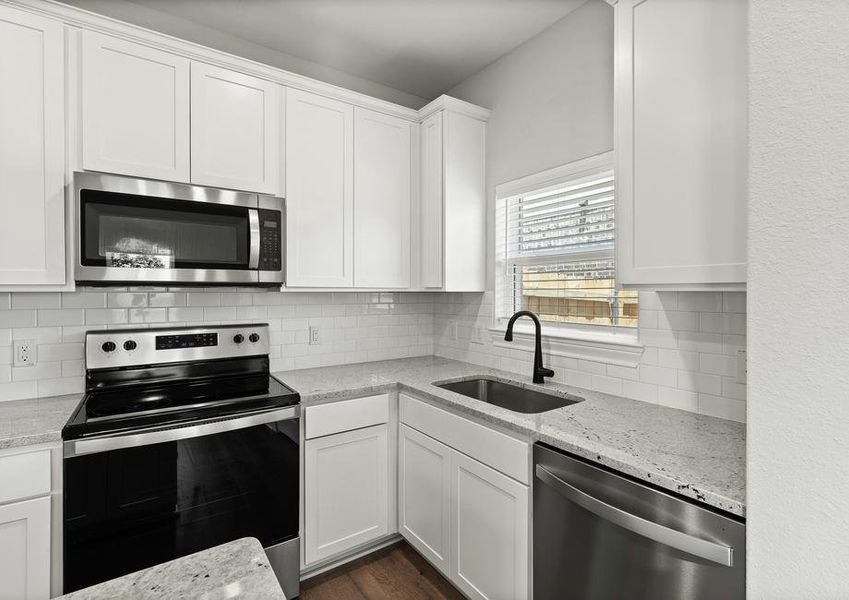 The kitchen of the Sabine floor plan has sprawling granite countertops.