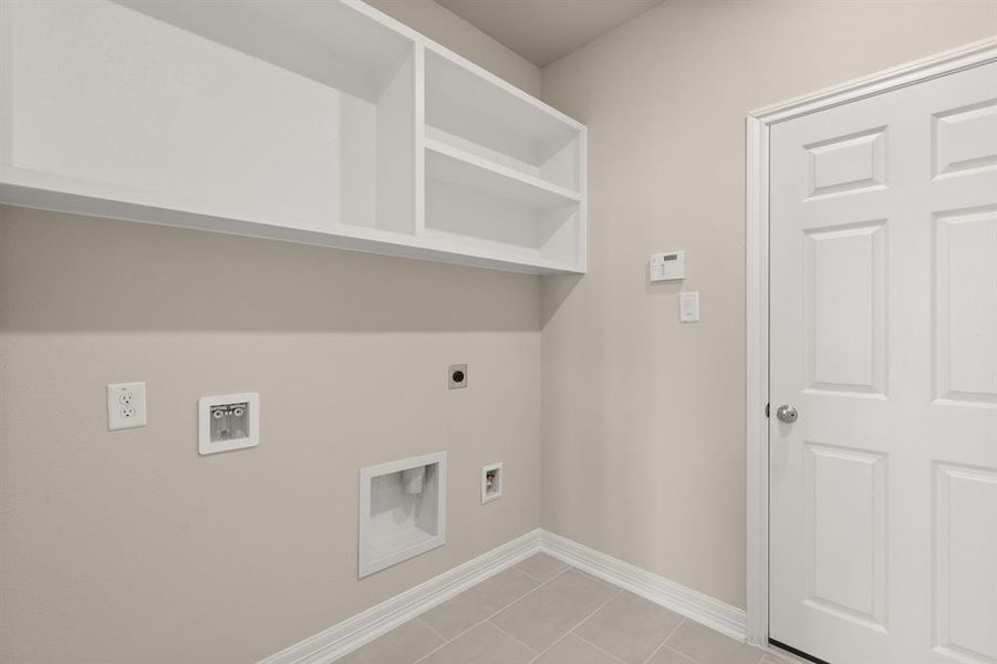 The laundry room layout is carefully planned for optimal workflow with designated areas for washing, drying, and storing.