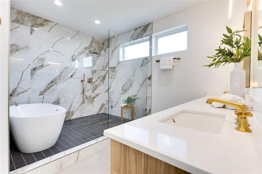 Bathroom with vanity, tile patterned flooring, and plus walk in shower