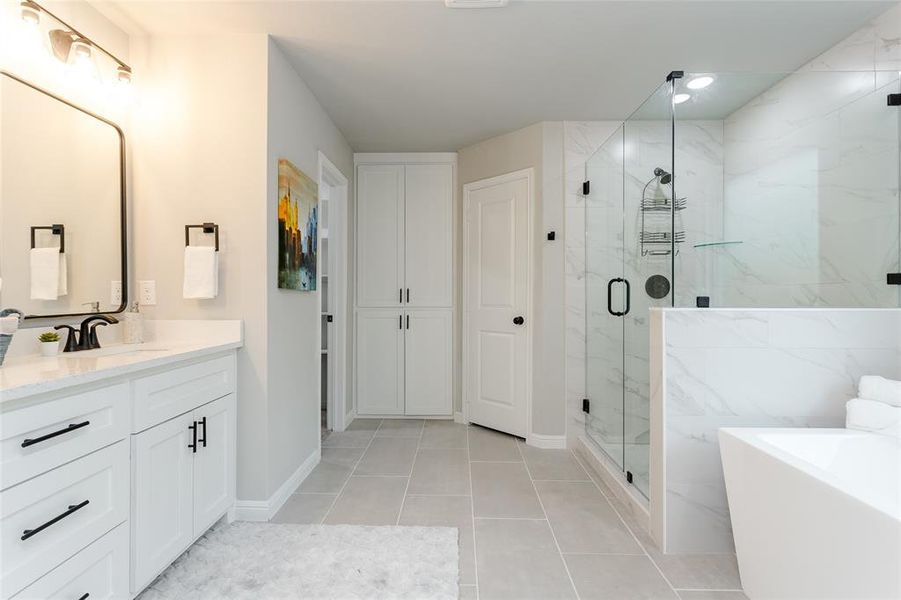 Bathroom with vanity, plus walk in shower, and tile patterned flooring