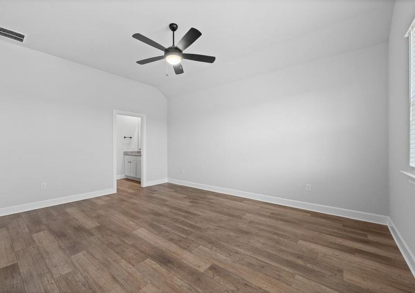 <p>Master Suite featuring high ceilings and vinyl flooring with a peek into the master bathroom. </p>