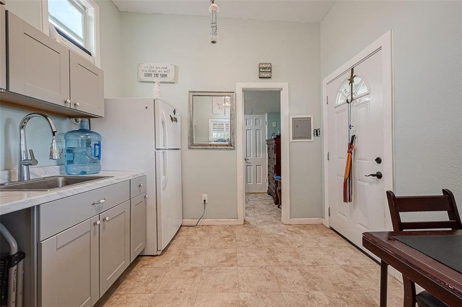 The kitchen is positioned adjacent to the bathroom, providing convenient access between these essential areas of the home for efficient daily routines and easy navigation within the living space.