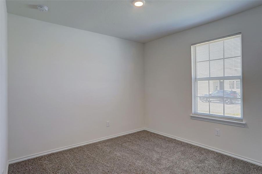 Empty room with plenty of natural light and carpet flooring