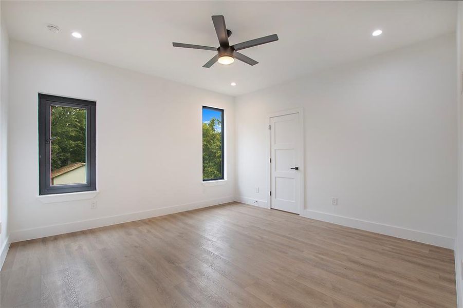 Spare room with ceiling fan and light hardwood / wood-style floors