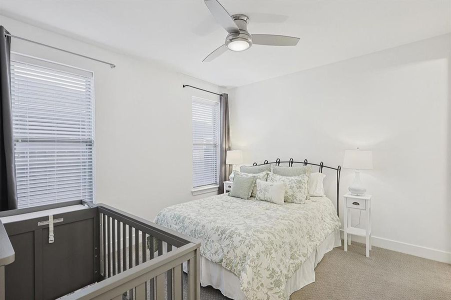 Carpeted bedroom with ceiling fan