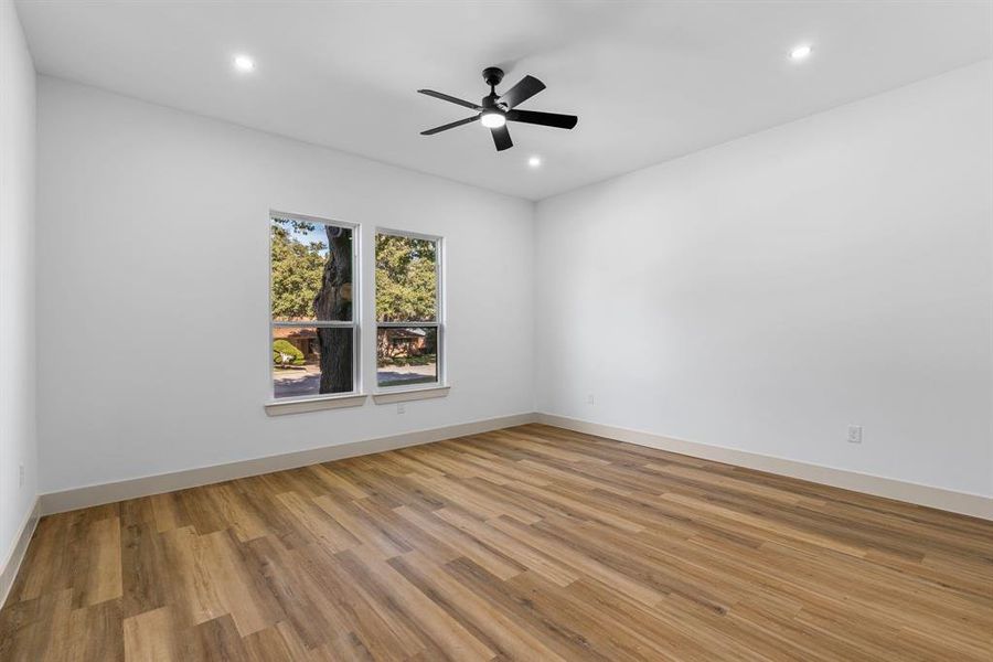 Unfurnished room featuring light wood-type flooring and ceiling fan