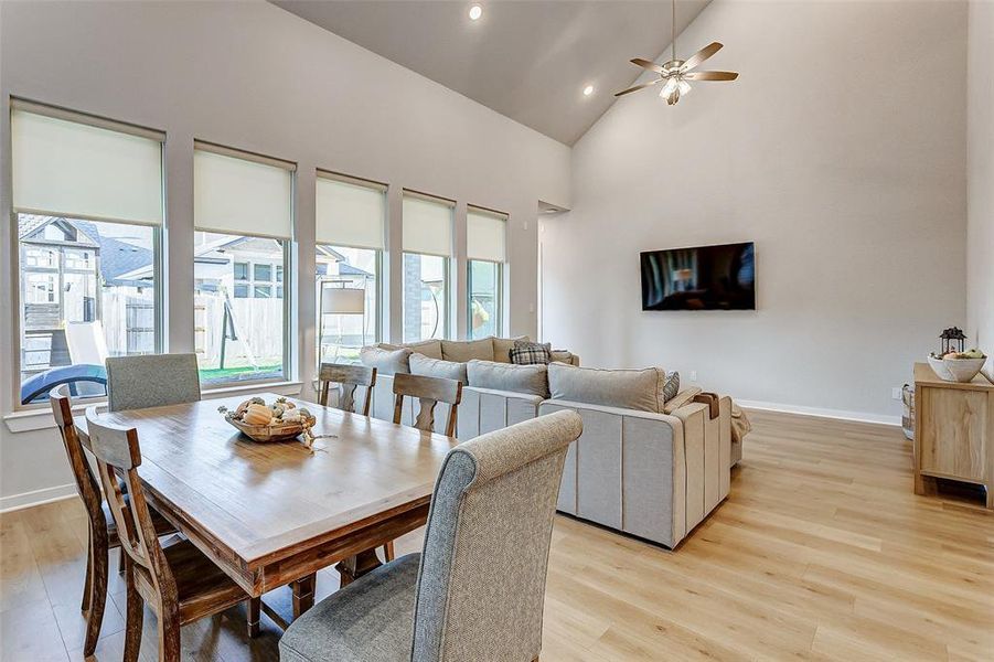 This open concept living area is covered in large windows that let in tons of natural light to create a feeling of indoor/outdoor living.