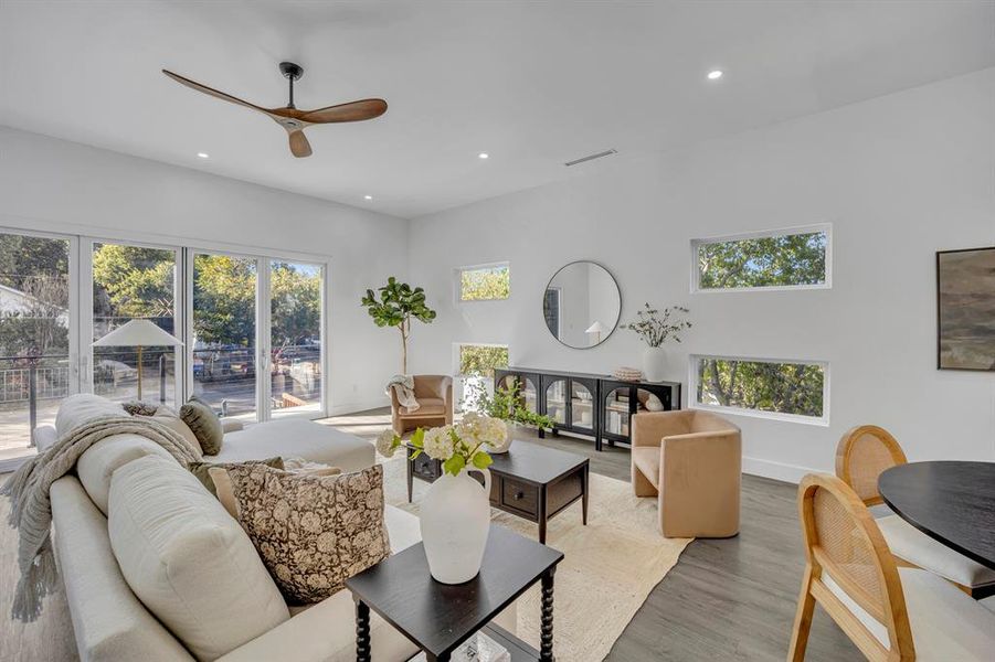 Living room featuring light hardwood / wood-style flooring, a healthy amount of sunlight, and ceiling fan