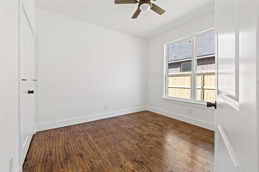 Empty room featuring wood-type flooring and ceiling fan