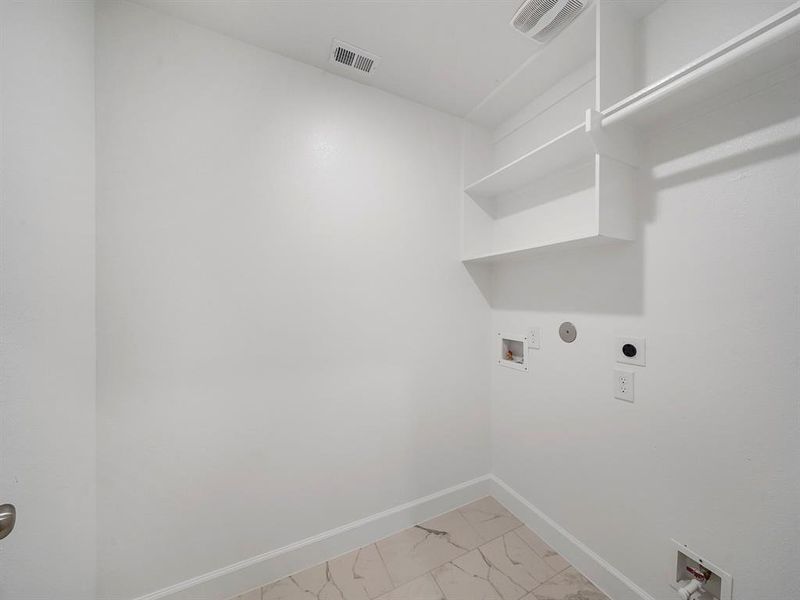 The Utility Room is located on the second floor, and features built-in shelves for additional storage. (Sample photos of a completed Sterling floor plan. The image may feature alternative selections and/or upgrades.)