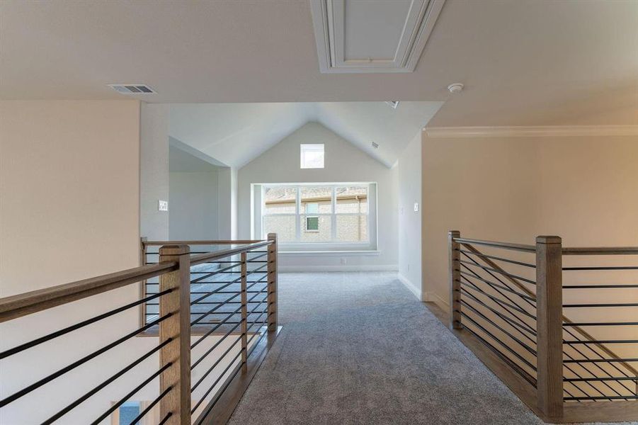 Hallway featuring lofted ceiling and carpet floors