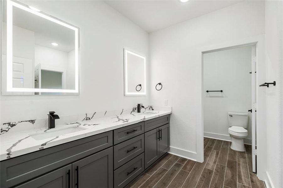 With a double vanity and plenty of storage, there's enough room for everyone in this shared space