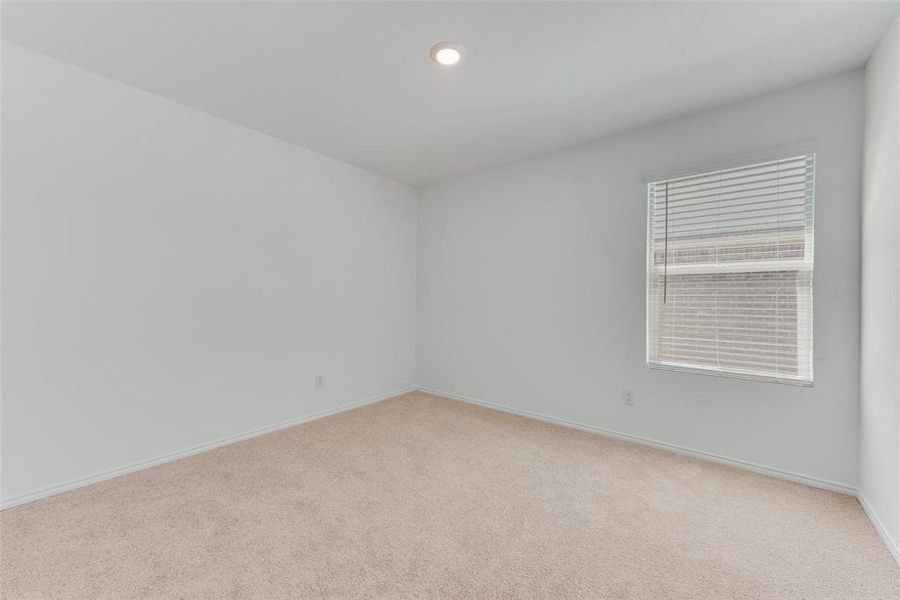 Unfurnished room featuring light colored carpet