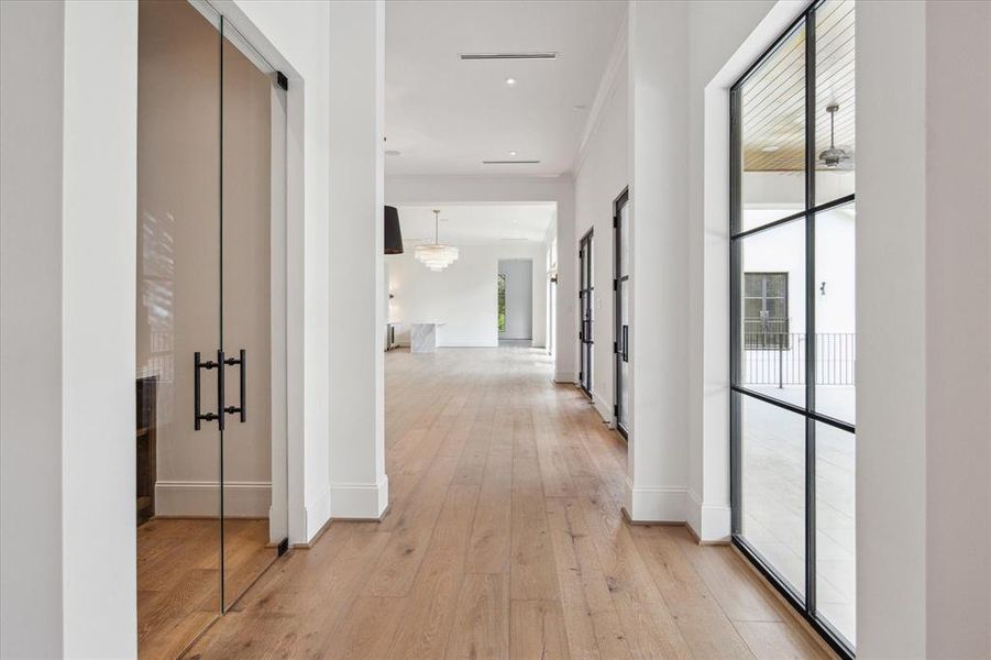 With its sleek glass door entry, this wine room holds over 200 bottles and is a stunning focal point in the heart of the home. Positioned just steps from the dining room and kitchen, it's ideally situated for effortless entertaining.