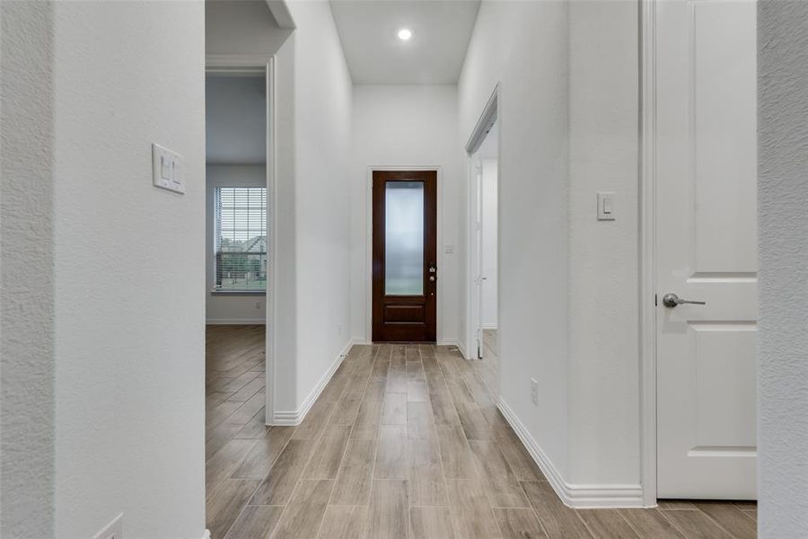 Corridor with light hardwood / wood-style flooring