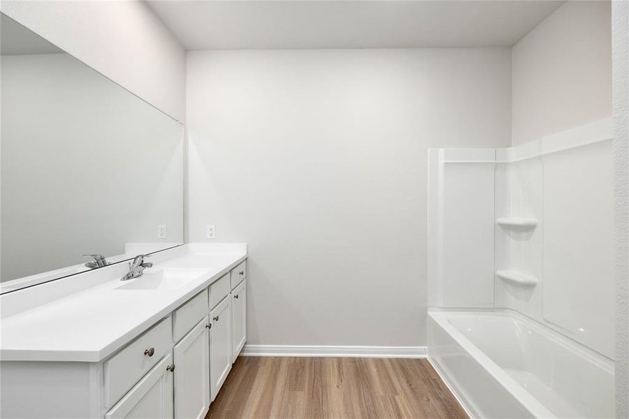 The master bathroom has a beautiful and spacious layout for your and your spouse to get ready for work in the morning. Enjoy the large shower-bath combo and upgraded luxury plank floors.