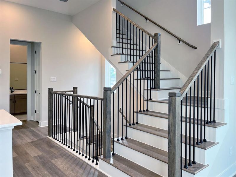 Dramatic double-height entry with an elegant open staircase design.