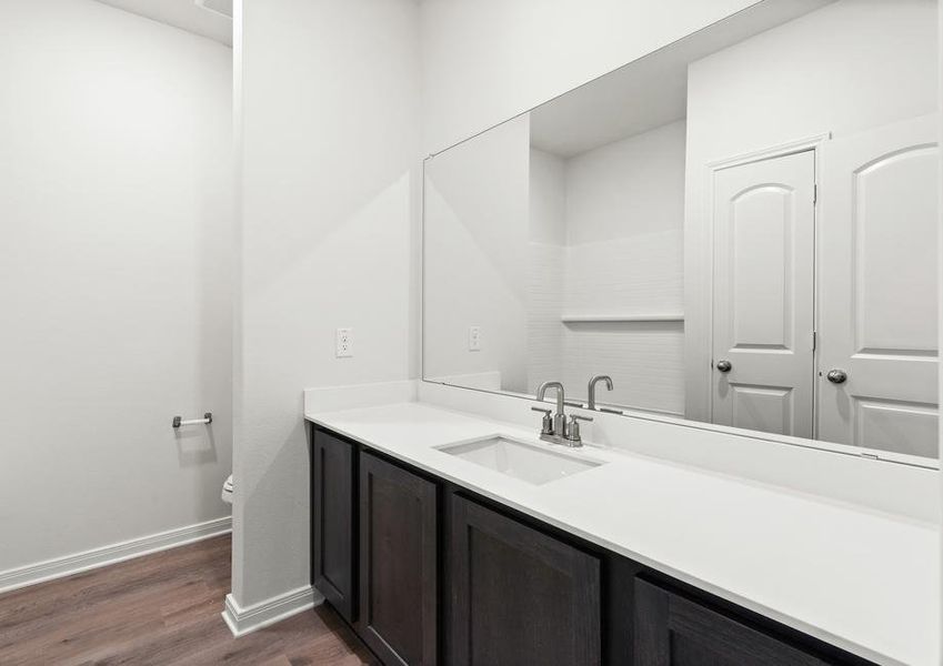 The secondary bathroom has a large vanity space.