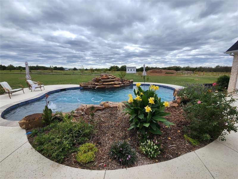 View of pool featuring a lawn and a patio