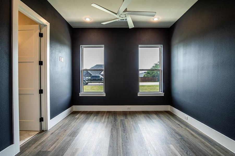 Spare room with plenty of natural light, ceiling fan and private bath