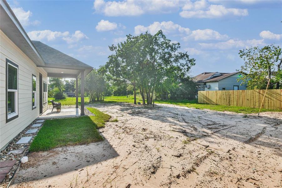 View of covered patio and large backyard.