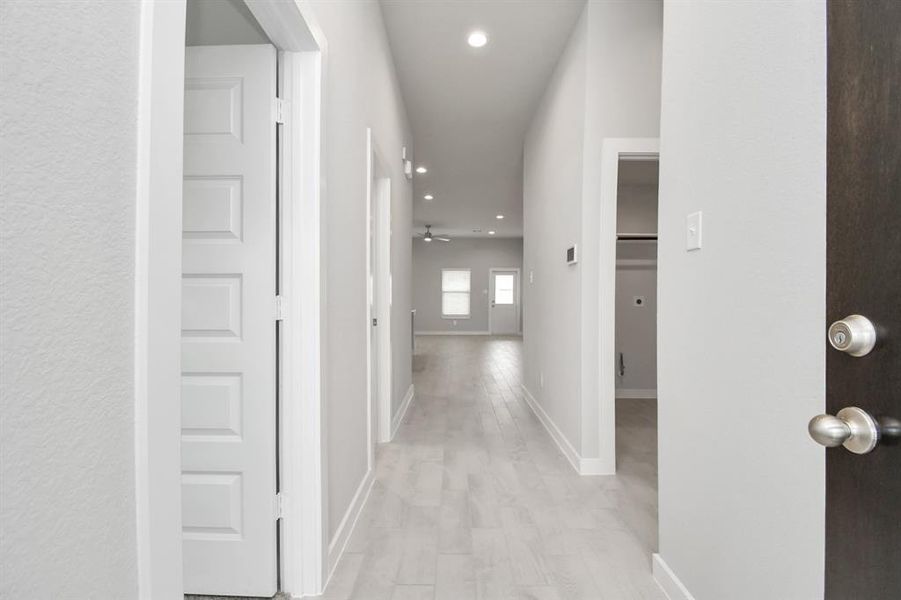 As you step into the threshold of this luxurious home, you'll soon be welcomed by an elegant glass door. Inside, soaring ceilings amplify the spaciousness, while the refined wood-look tile flooring and oversized baseboards exude sophistication and charm.