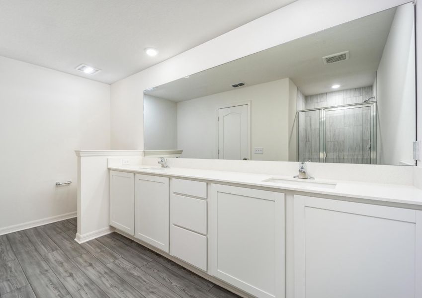 The master bathroom has a long vanity perfect for getting ready each day