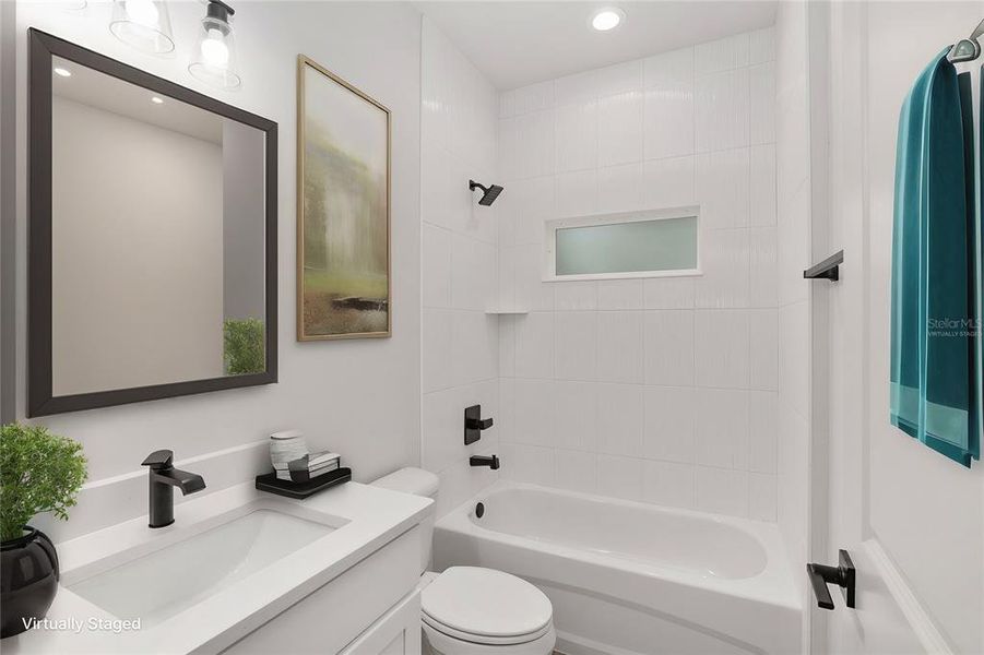 2nd Bathroom with Quartz Countertop, Bathtub, Ceramic Tile from Tub to Ceiling and Luxury Vinyl Plank Flooring (Virtually Staged)