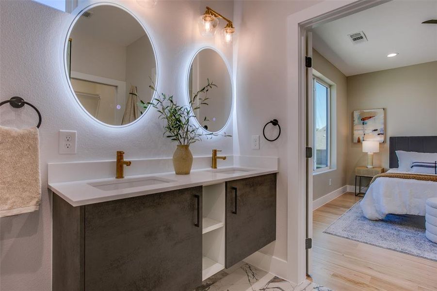 Bathroom with hardwood / wood-style flooring and double sink vanity