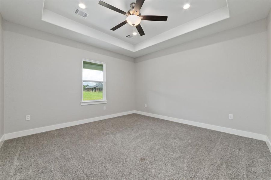 A vaulted ceiling in the primary bedroom adds depth and a sense of spaciousness, allowing you ample room to add your personal touch and create a space that truly reflects your style and comfort.