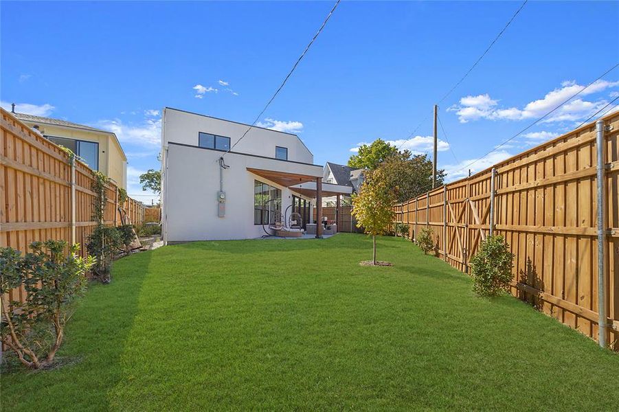 Back of house with a patio area and a yard