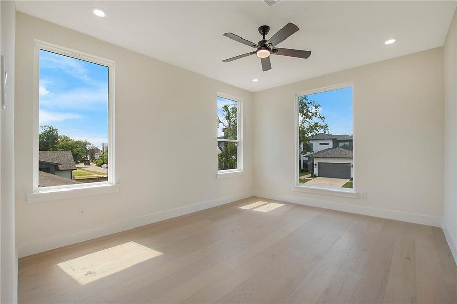 Spare room with hardwood / wood-style flooring and ceiling fan