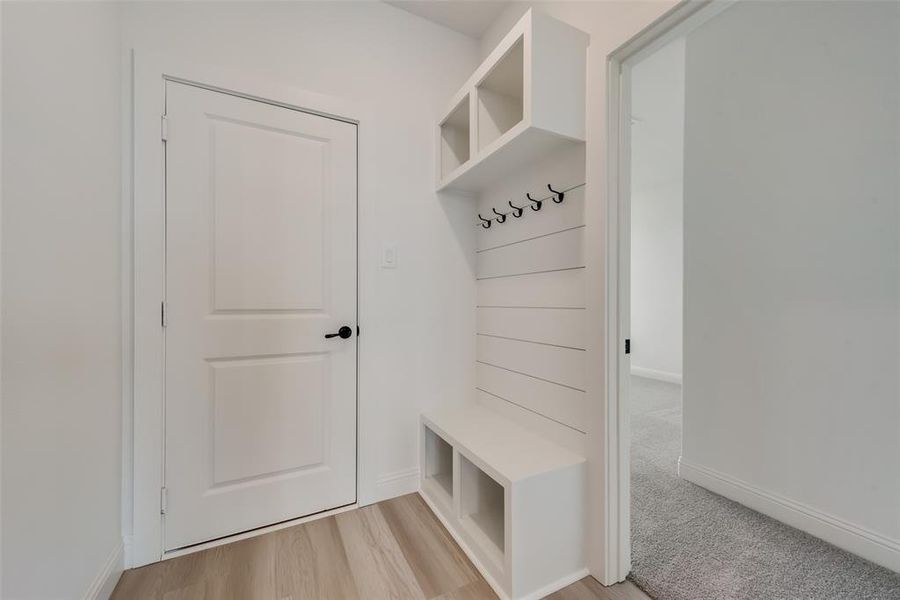 Mudroom featuring light colored carpet