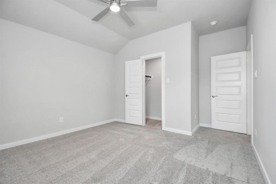 Secondary bedroom features plush carpeting, large windows that let in plenty of natural light, bright paint, and spacious closets.