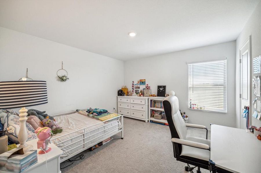 Spacious upstairs bedroom with plenty of natural light and closet space, perfect for a cozy retreat.