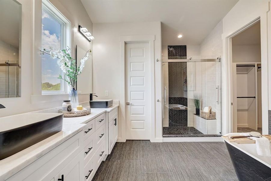 Beautiful primary bathroom with walk in shower and soaking tub, dual vanity.