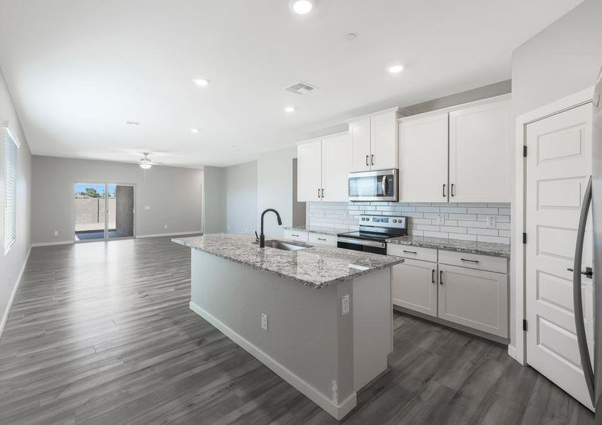 Upgraded kitchen with oversized island and granite countertops.