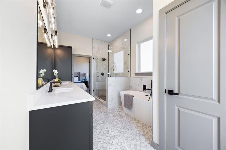 Bathroom featuring vanity, tile patterned flooring, and plus walk in shower