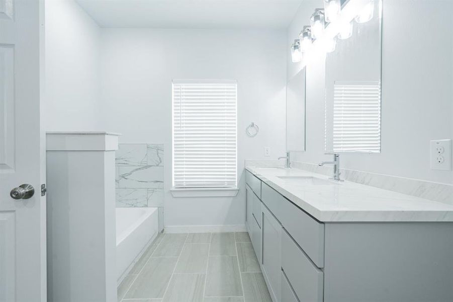 Bathroom featuring vanity and a bathing tub