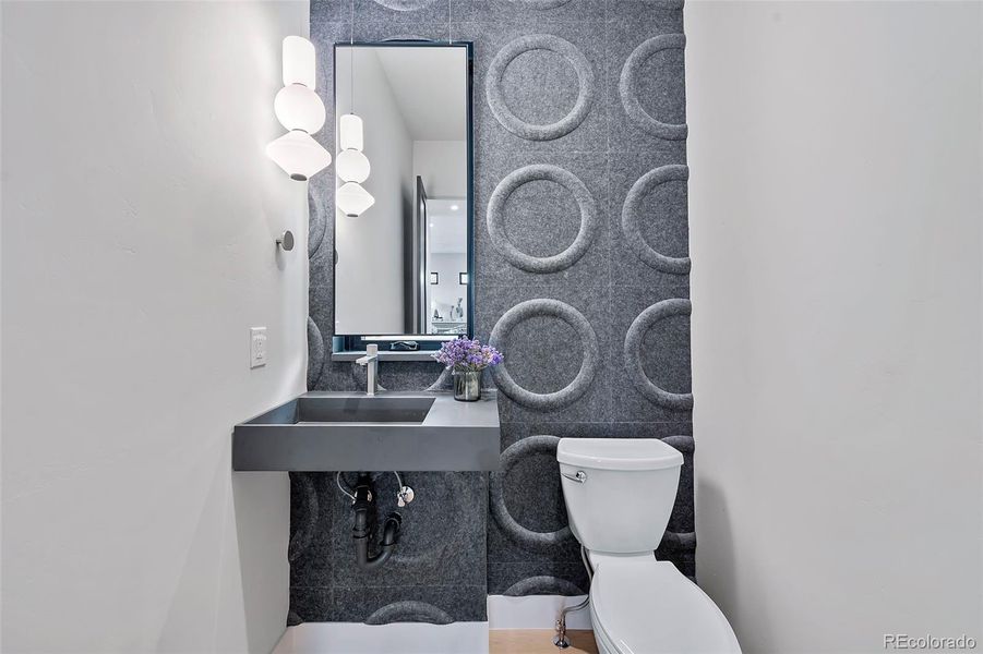 Powder bath textured wall makes this functional space a standout.