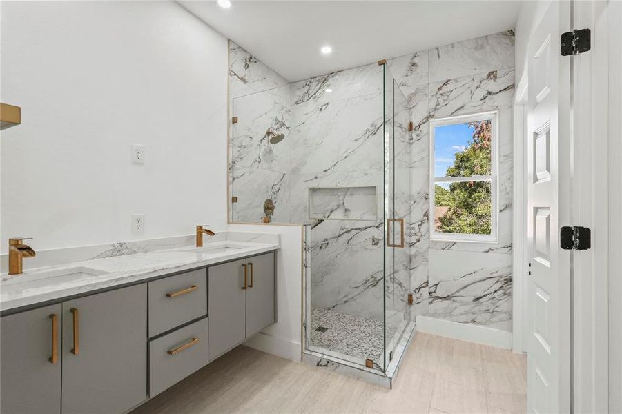 Bathroom featuring vanity, hardwood / wood-style flooring, and walk in shower