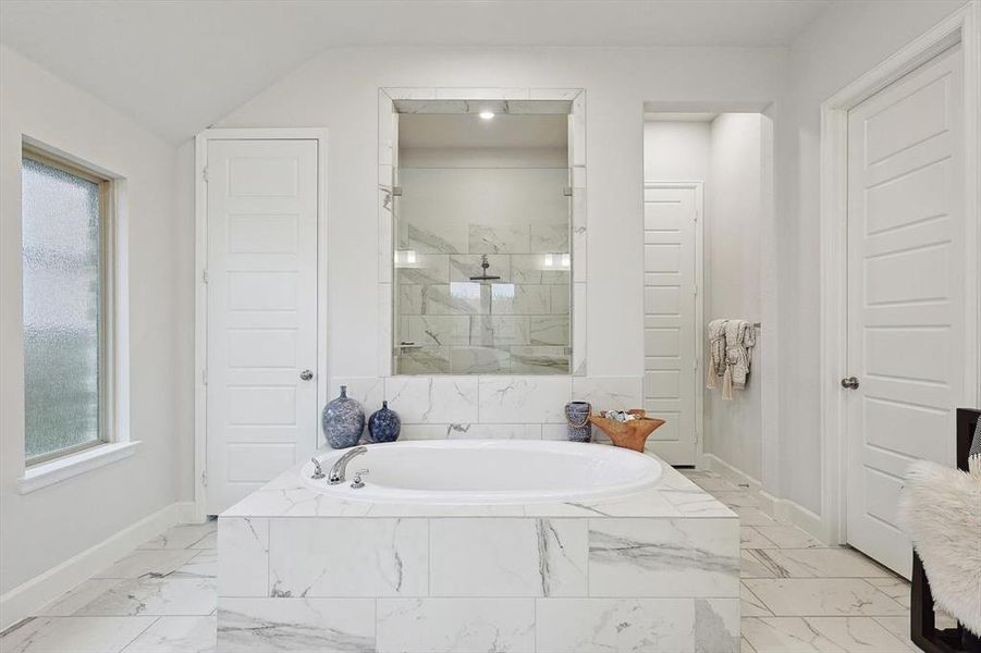 Bathroom with vaulted ceiling and separate shower and tub