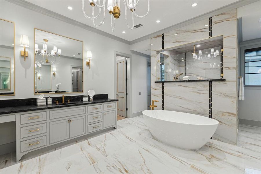 This phenomenal bath boasts dual vanities with brass sconces, a makeup station, a freestanding tub, and a walk-in shower with Riobel fixtures. Dual shower doors and water closets for convenience and privacy.