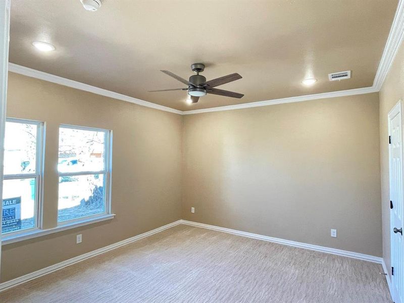 Carpeted empty room with ornamental molding and ceiling fan