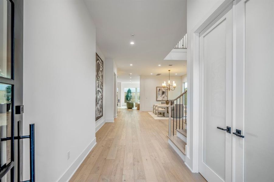 Welcome inside this grand foyer where 7-inch white oak planks greet you and grace the entire expansive first floor. Double French doors open up to your first-floor office/study/flex room.
