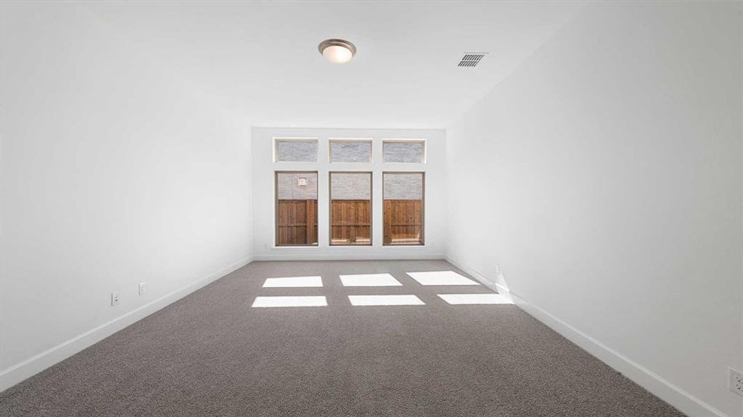 Spare room featuring light colored carpet