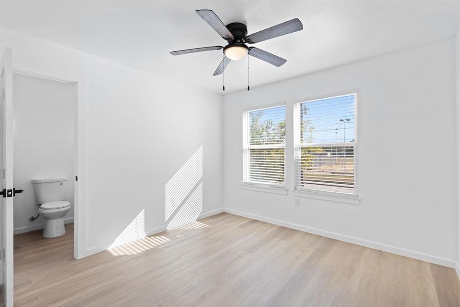 Unfurnished room with light wood-type flooring and ceiling fan