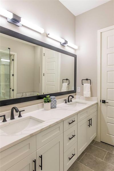 Bathroom with double sink, tile floors, and large vanity