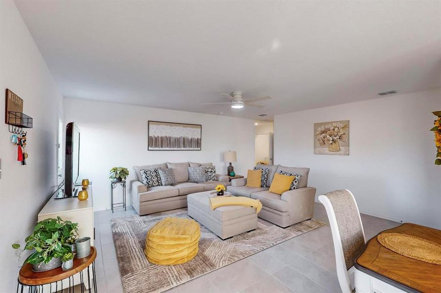 Tiled living room featuring ceiling fan